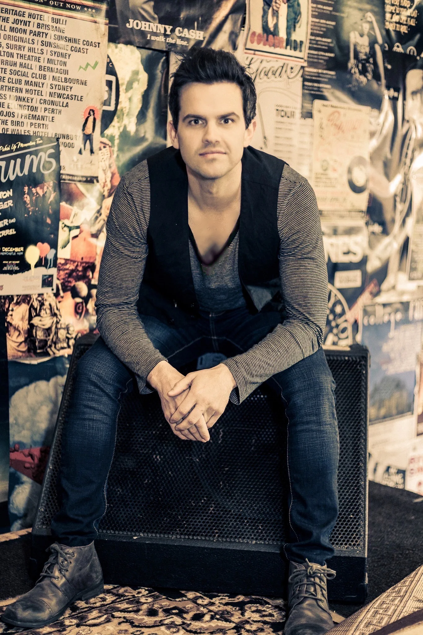 Chris Read seated in front of a wall of music posters